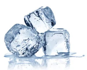 Three transparent ice cubes with water droplets on white background