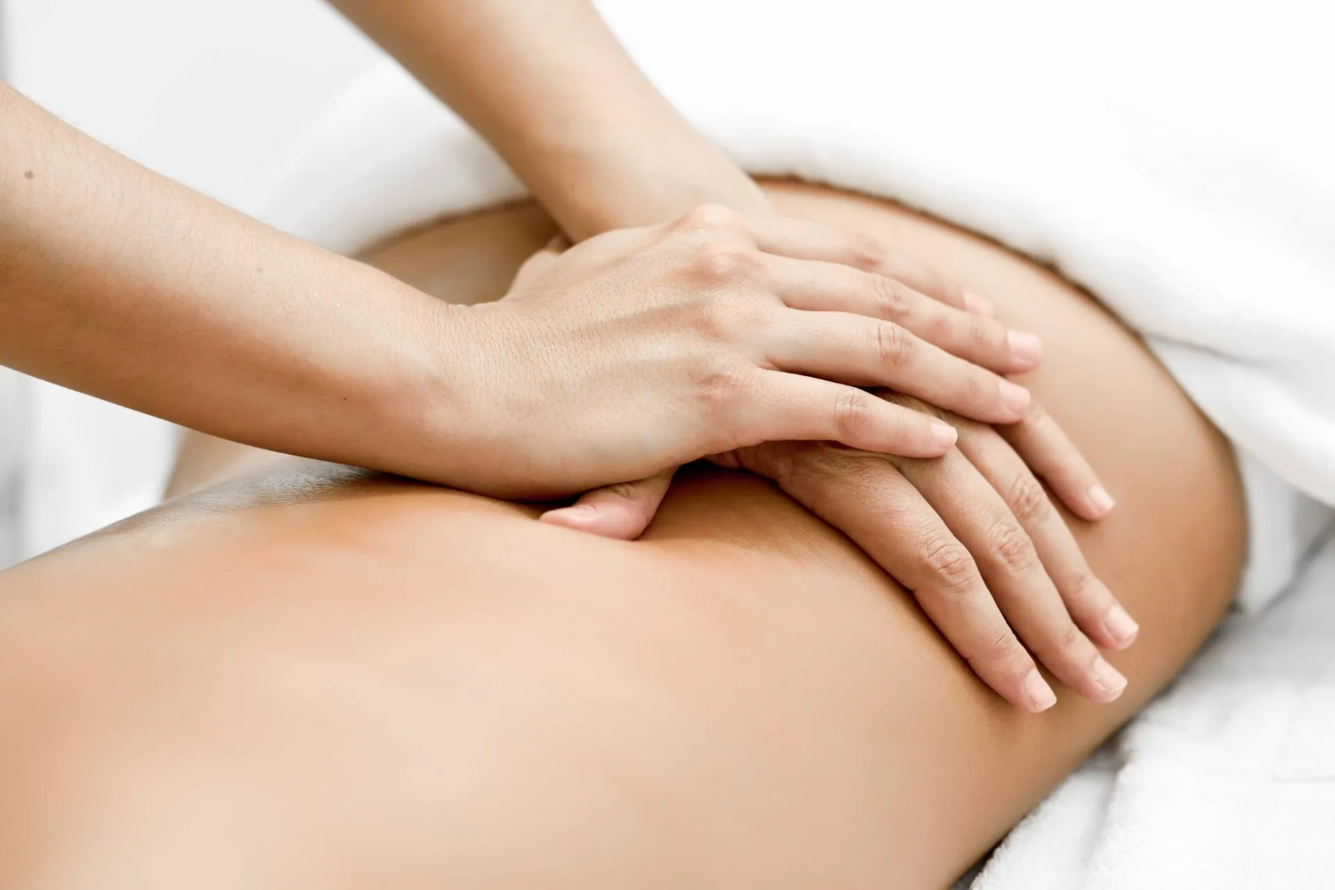 Therapist's hands performing massage on patient's leg
